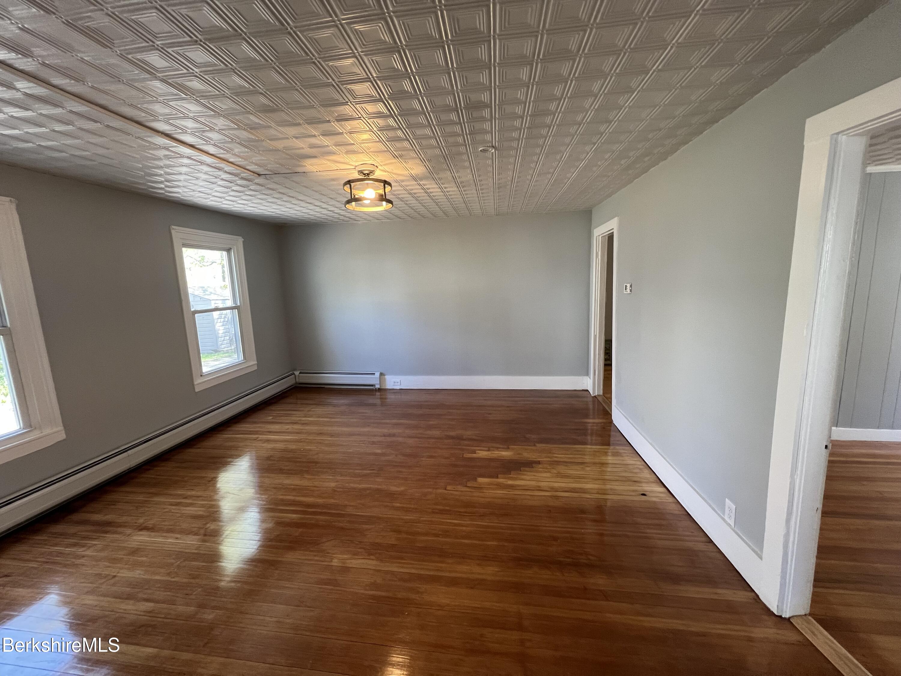 71 Howard Street Pittsfield, MA 01201 - Photo 16 of 42 a view of an empty room with wooden floor and a window