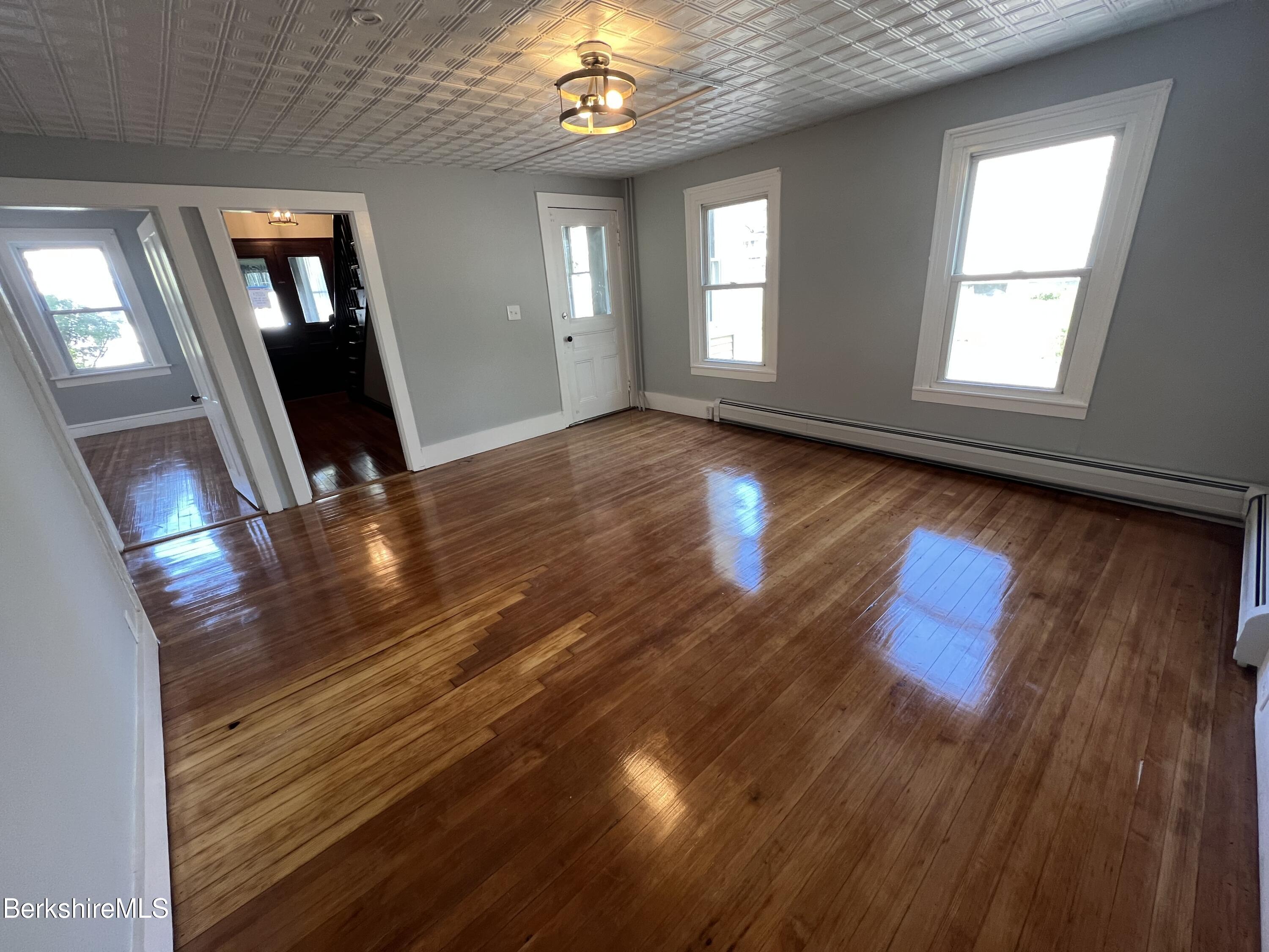 71 Howard Street Pittsfield, MA 01201 - Photo 17 of 42 wooden floor in an empty room with a window
