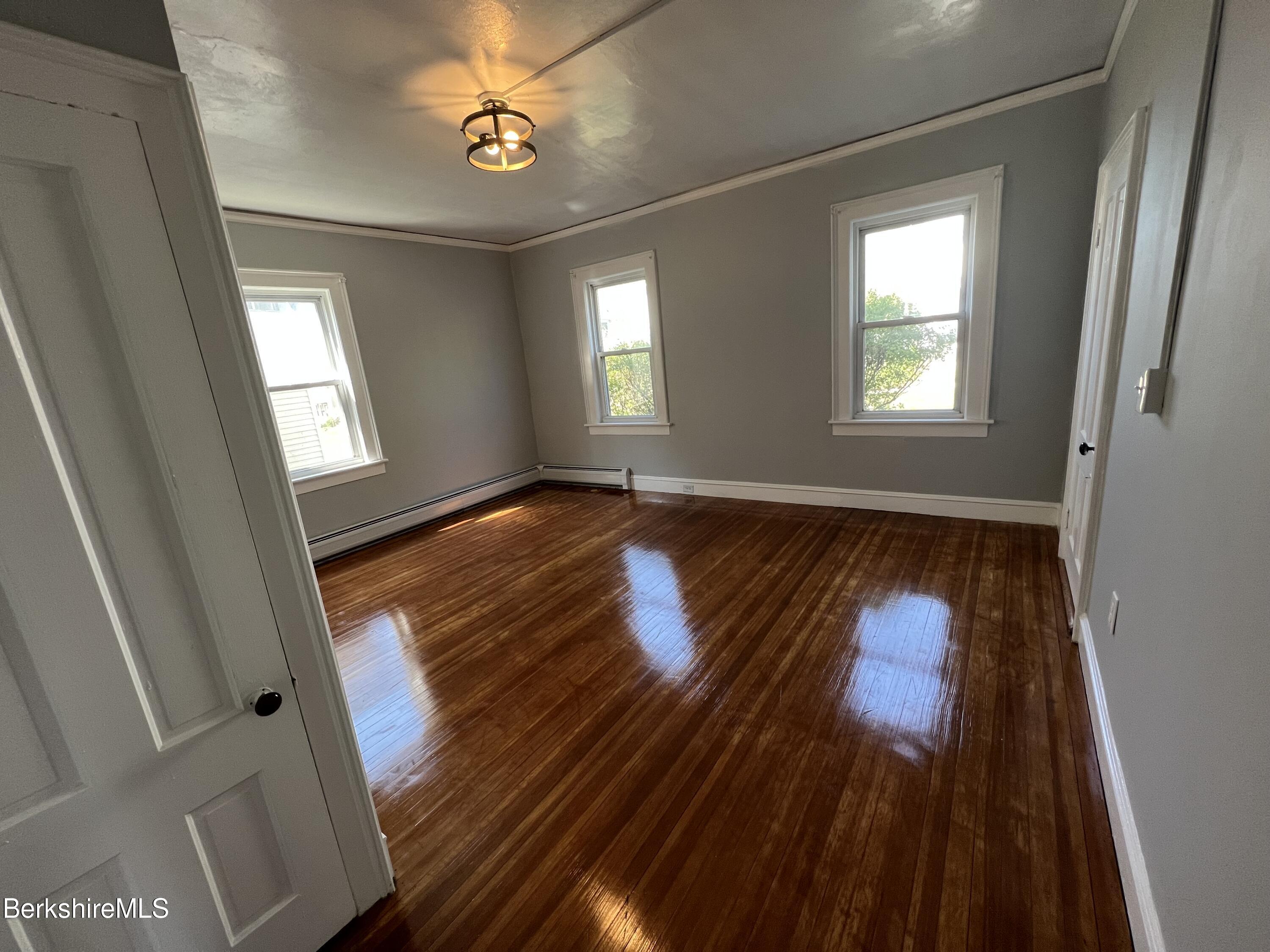 71 Howard Street Pittsfield, MA 01201 - Photo 18 of 42 wooden floor in an empty room with a window