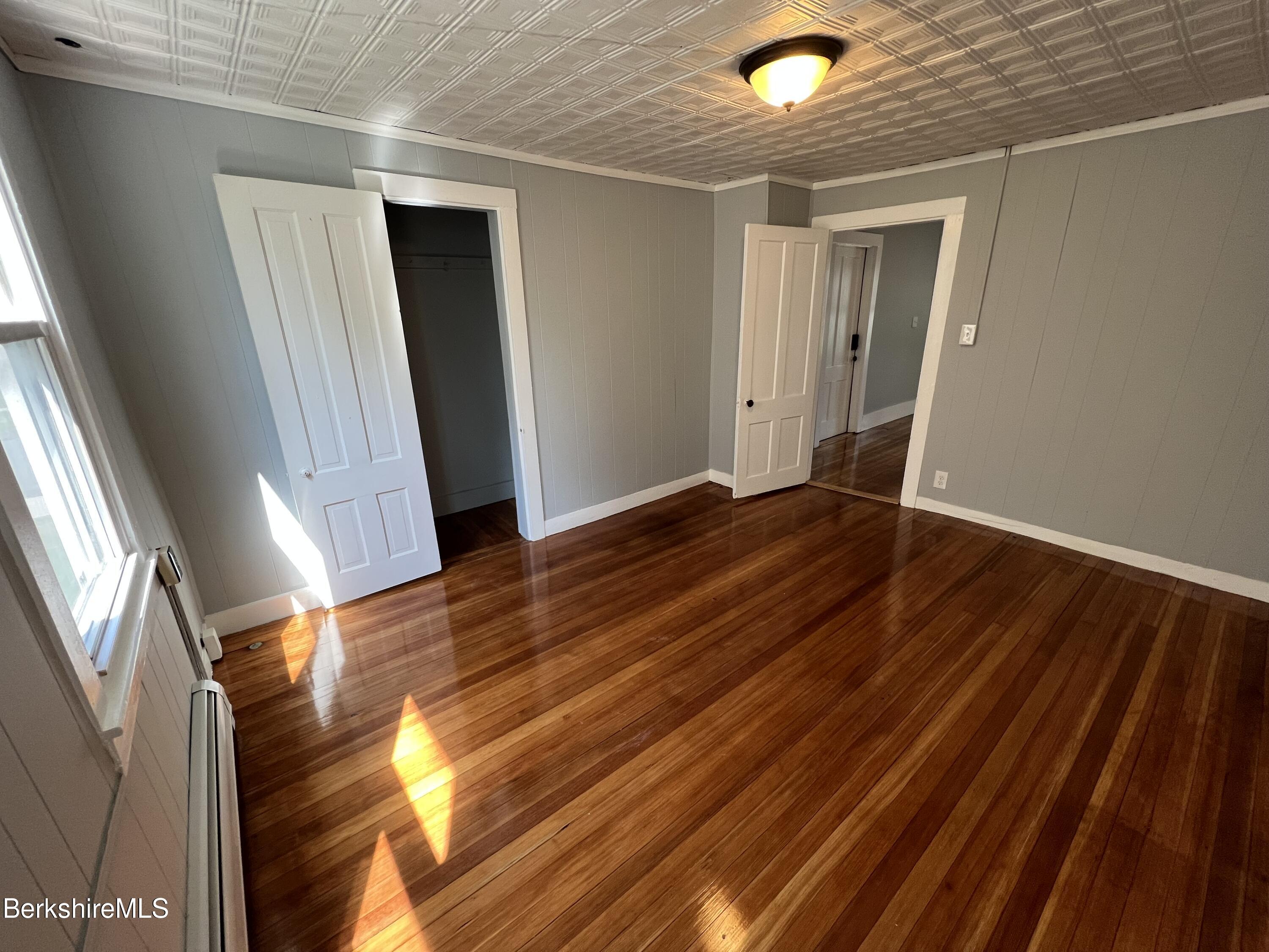 71 Howard Street Pittsfield, MA 01201 - Photo 20 of 42 a view of an empty room with wooden floor and a window