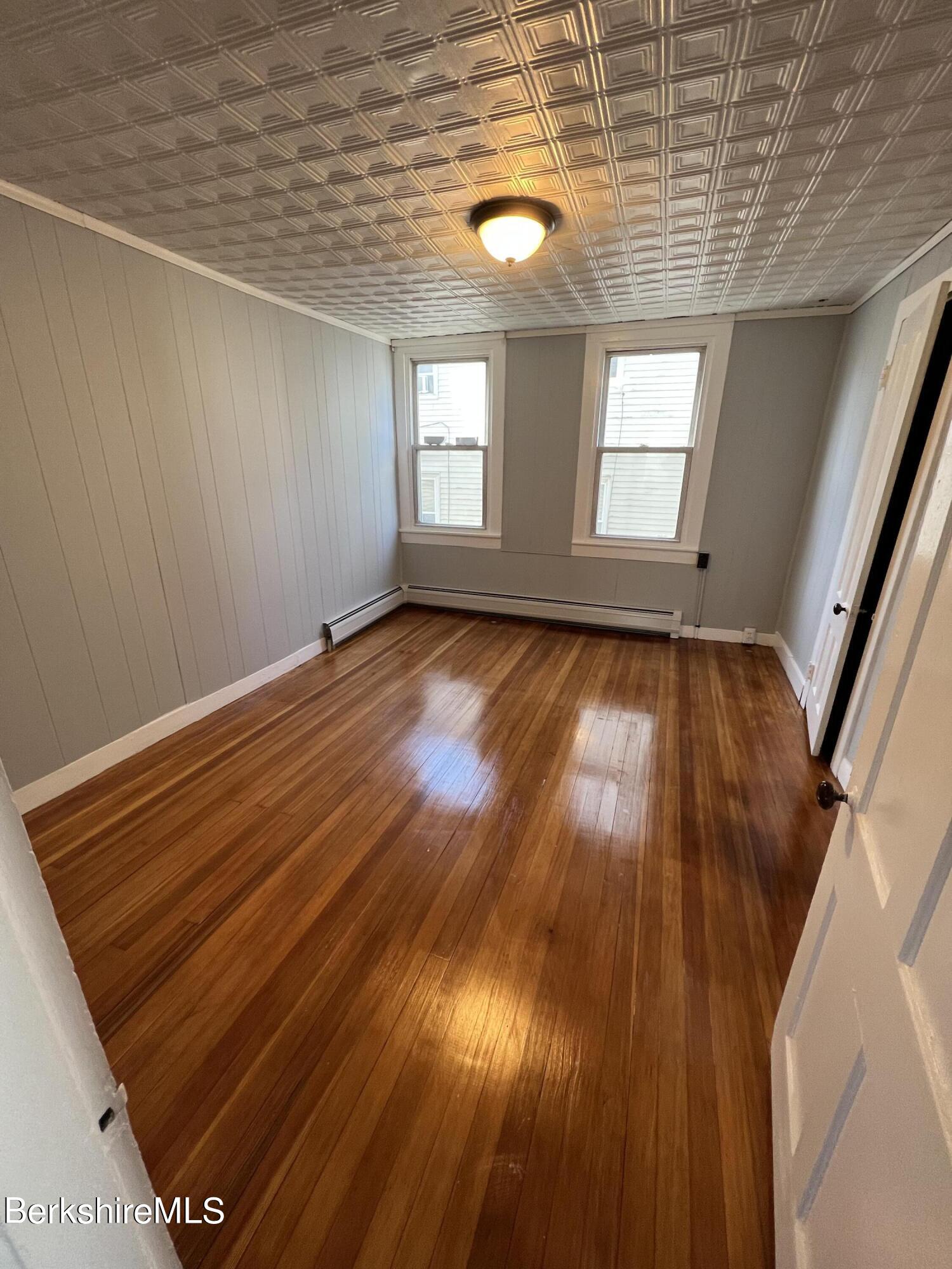 71 Howard Street Pittsfield, MA 01201 - Photo 21 of 42 a view of an empty room with wooden floor and window