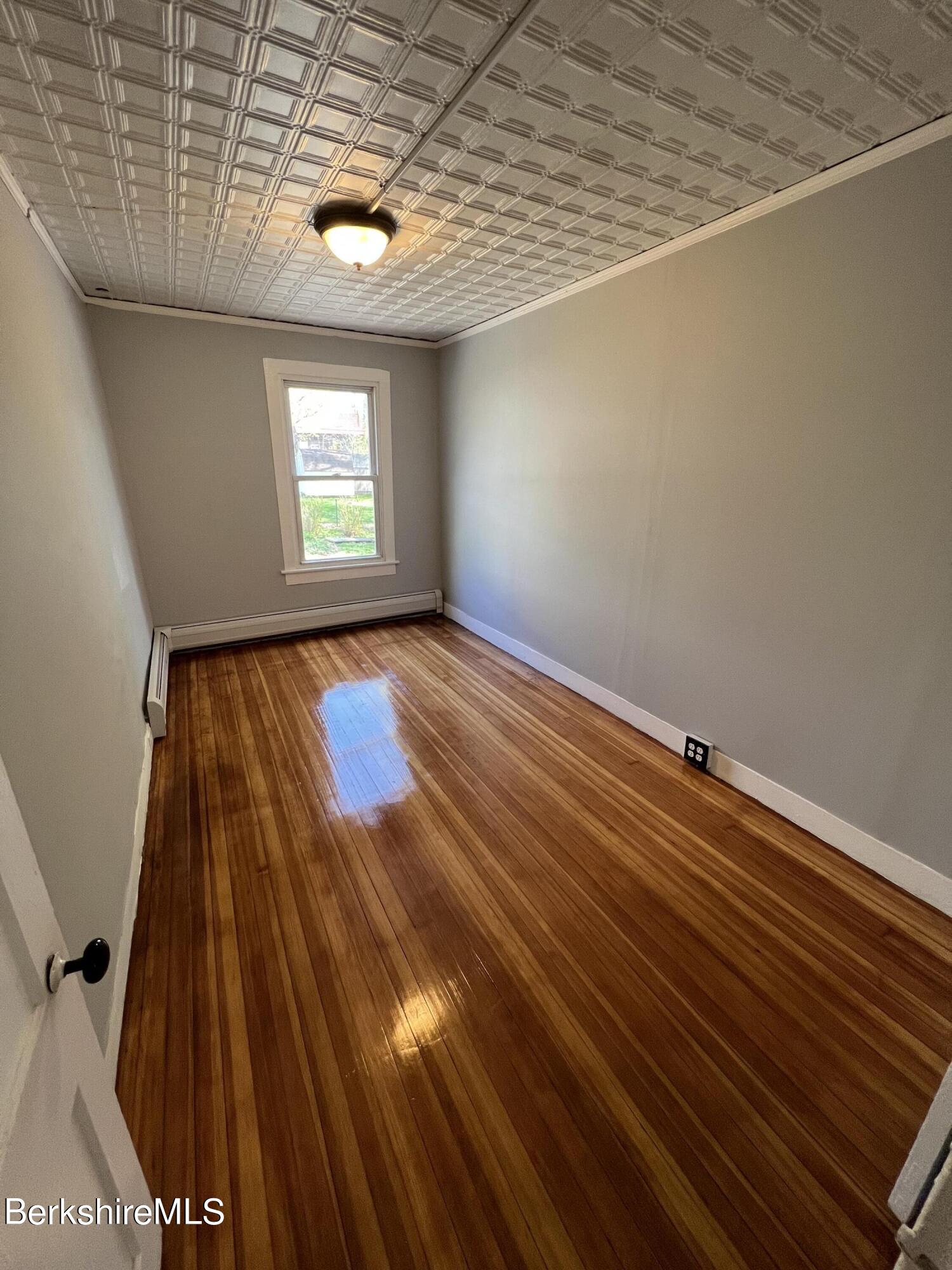 71 Howard Street Pittsfield, MA 01201 - Photo 23 of 42 a view of a room with wooden floor and window
