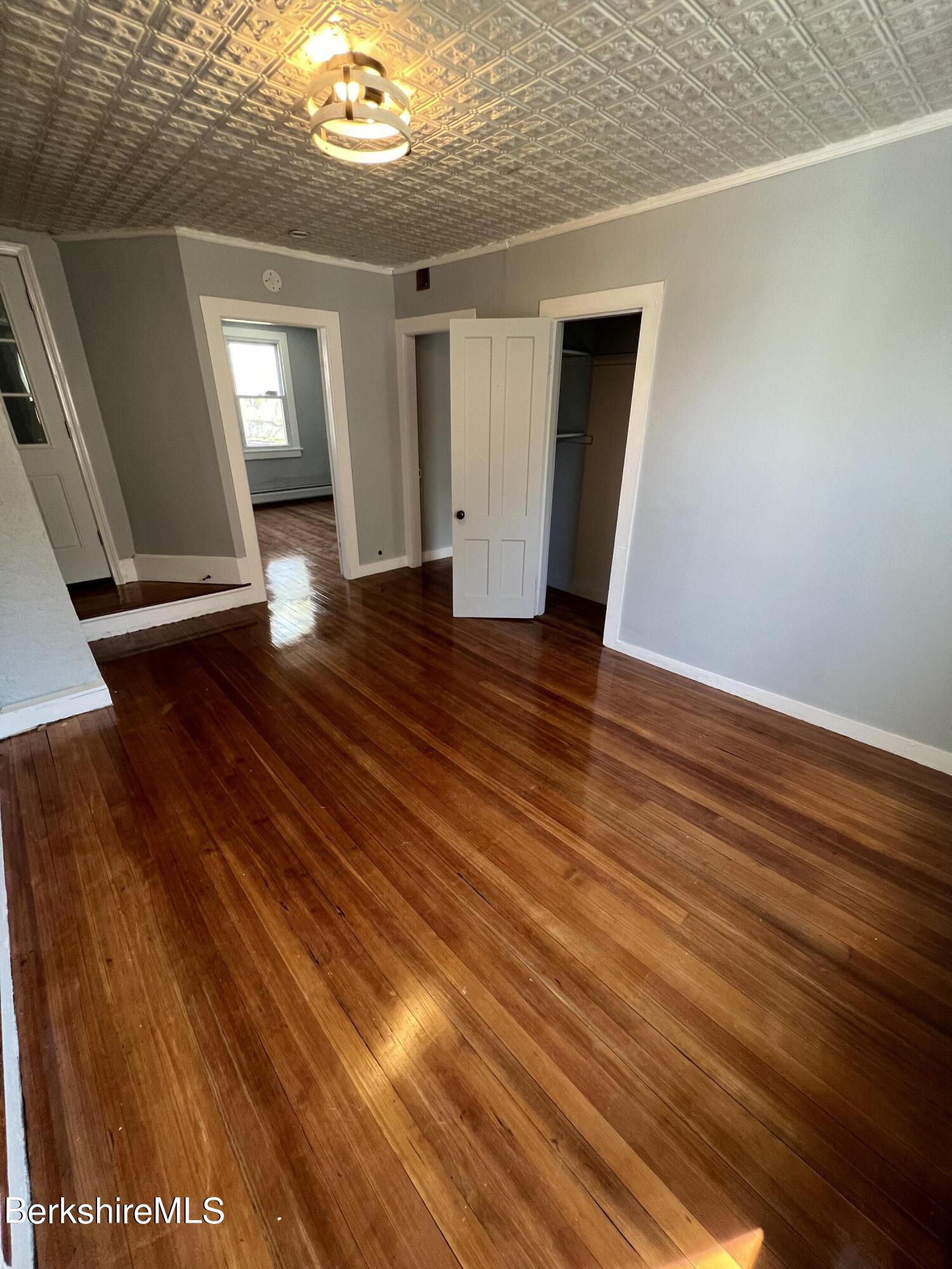 71 Howard Street Pittsfield, MA 01201 - Photo 30 of 42 a view of an empty room with wooden floor and a window