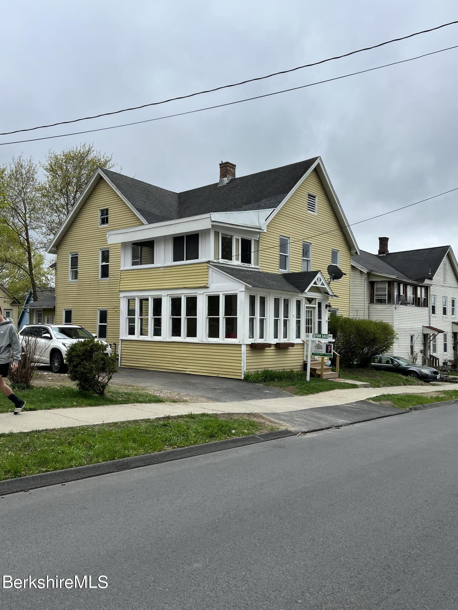 71 Howard Street Pittsfield, MA 01201 - Photo 3 of 42 a front view of a house with a garden and trees