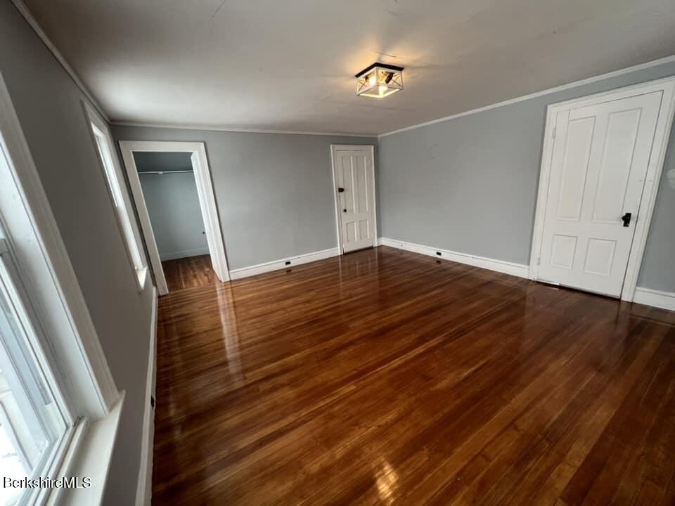 71 Howard Street Pittsfield, MA 01201 - Photo 32 of 42 a view of an empty room with wooden floor and stairs