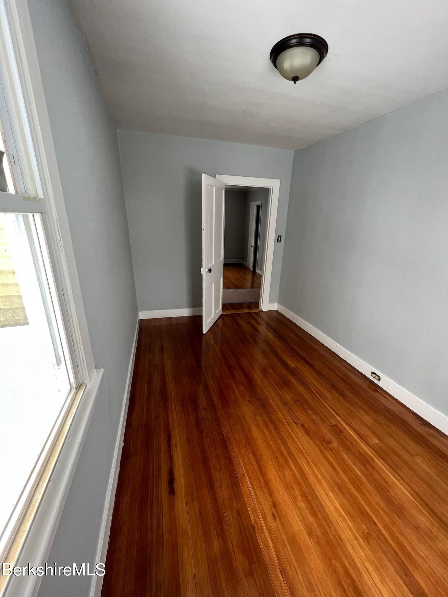 71 Howard Street Pittsfield, MA 01201 - Photo 36 of 42 a view of a room with wooden floor and window