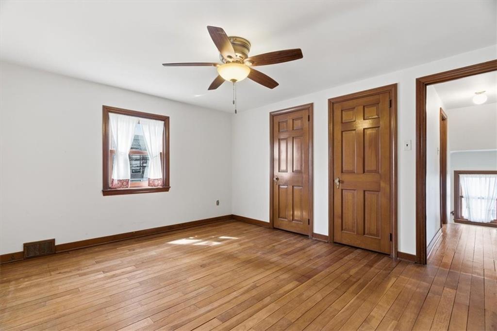 30 Warriors Road Pittsburgh, PA 15220 - Photo 12 of 30 a view of an empty room with wooden floor and a ceiling fan