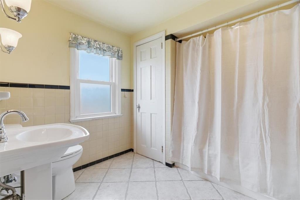 30 Warriors Road Pittsburgh, PA 15220 - Photo 18 of 30 a bathroom with a sink a toilet and shower