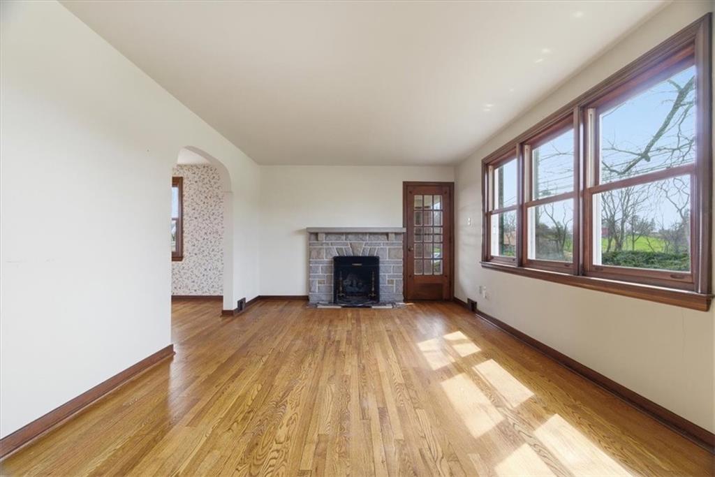 30 Warriors Road Pittsburgh, PA 15220 - Photo 3 of 30 a view of an empty room with exposed radiator and fireplace