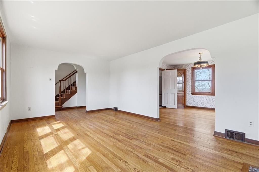 30 Warriors Road Pittsburgh, PA 15220 - Photo 5 of 30 a view of an empty room with window and wooden floor