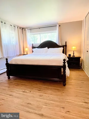 a bedroom with a bed and window