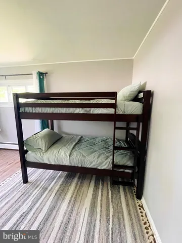 a bathroom with a granite countertop toilet sink and mirror