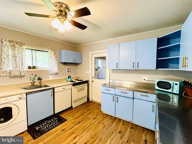 a kitchen with a sink cabinets and window