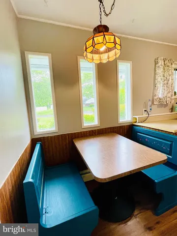 a dining room with furniture and wooden floor