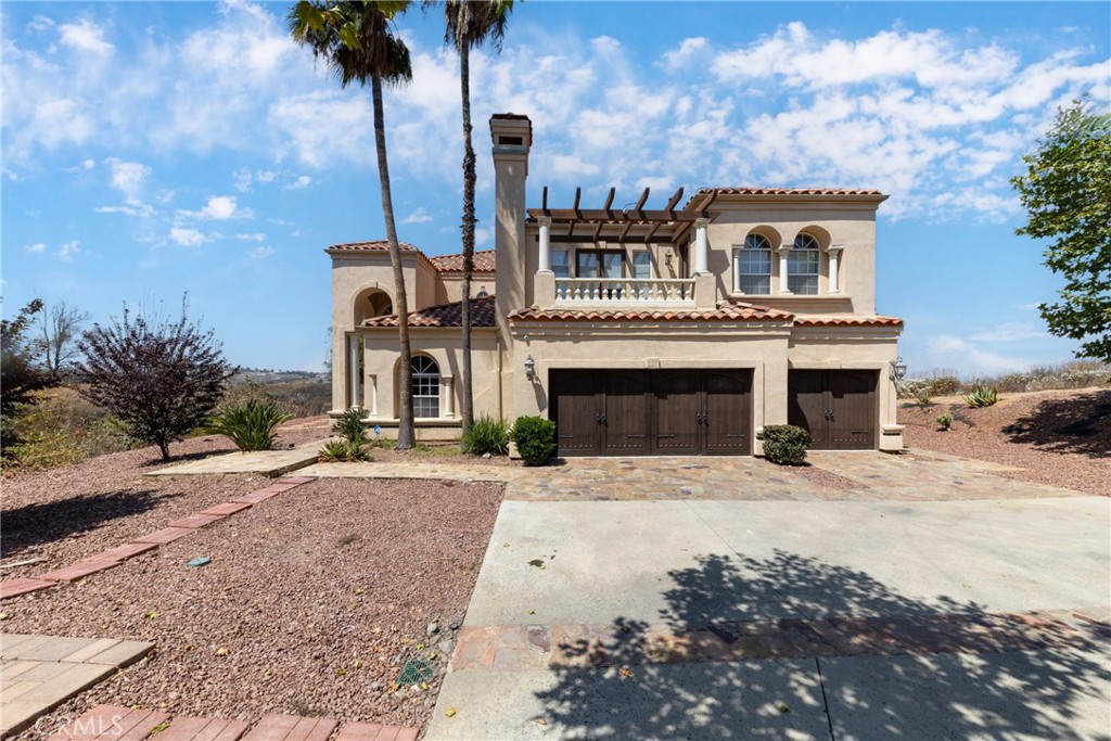 7007 Golden Vale Drive Riverside, CA 92506 - Photo 14 of 72 a front view of a house with yard and parking space