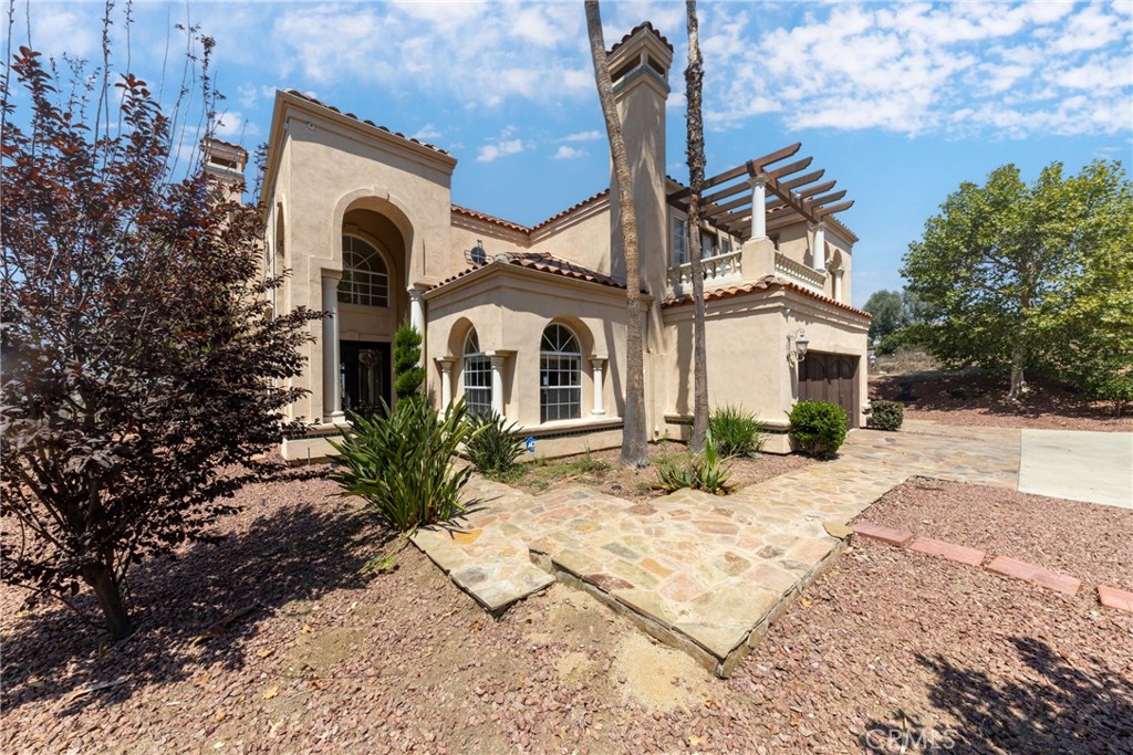 7007 Golden Vale Drive Riverside, CA 92506 - Photo 19 of 72 a front view of a house with a yard