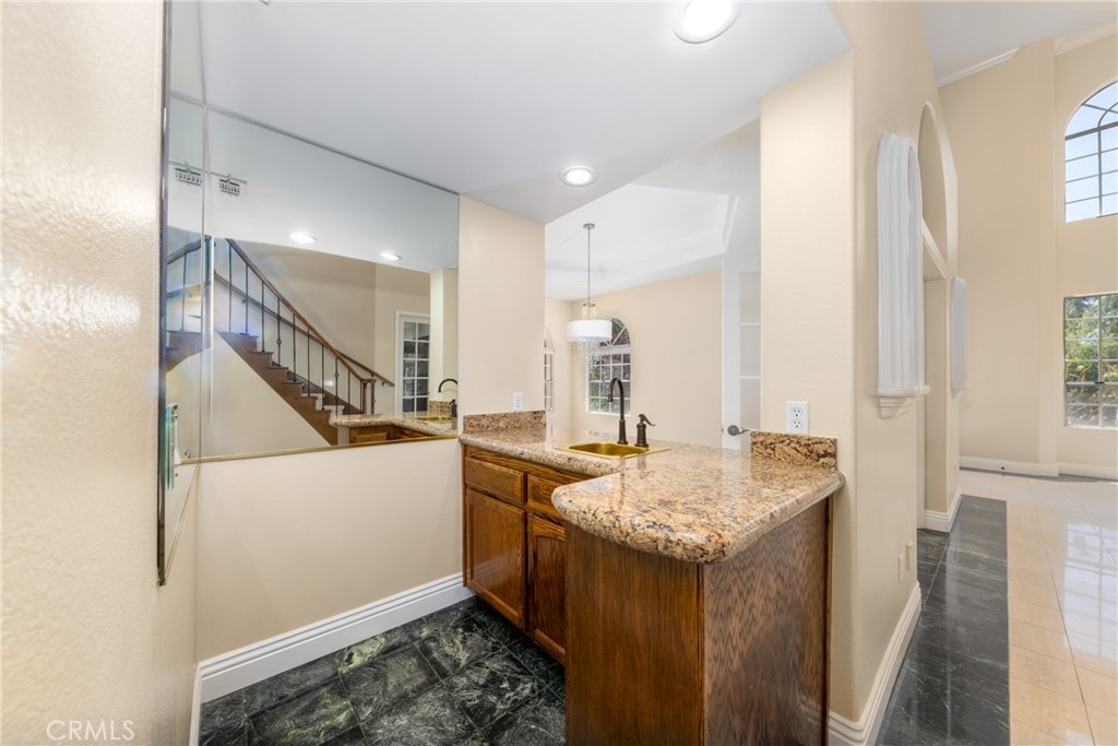 7007 Golden Vale Drive Riverside, CA 92506 - Photo 29 of 72 a bathroom with a granite countertop sink and a mirror