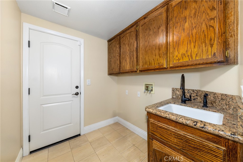 7007 Golden Vale Drive Riverside, CA 92506 - Photo 34 of 72 a kitchen with a sink and cabinets