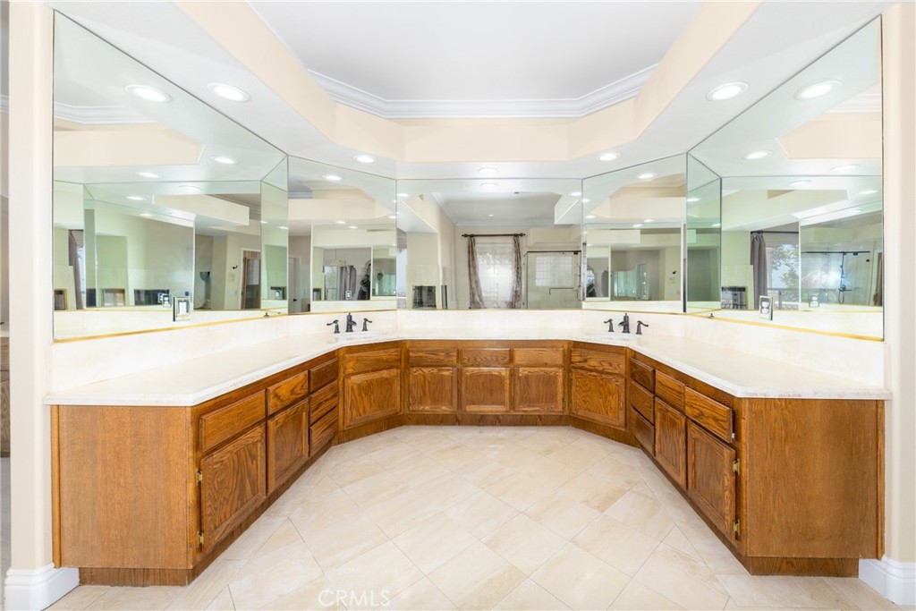 7007 Golden Vale Drive Riverside, CA 92506 - Photo 61 of 72 a large white kitchen with a large counter top a sink and stainless steel appliances