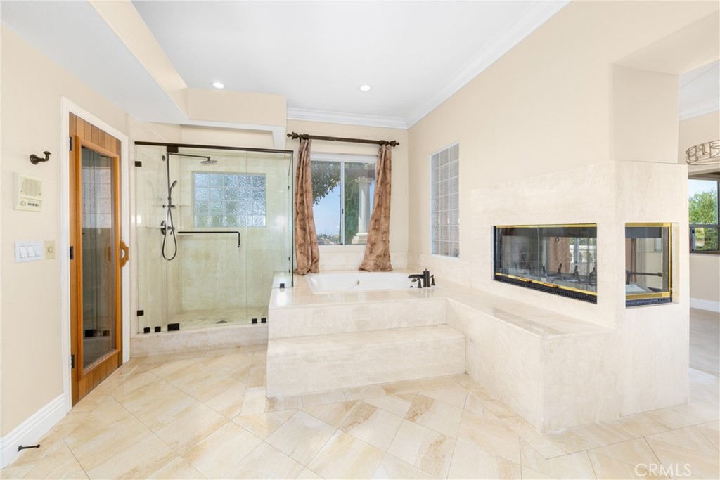 7007 Golden Vale Drive Riverside, CA 92506 - Photo 62 of 72 a spacious bathroom with a tub shower and mirror
