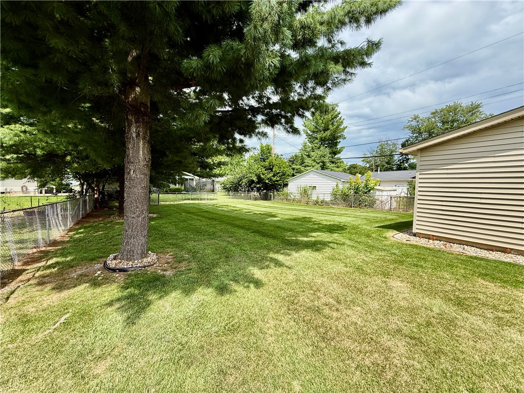 114 Columbus Drive Decatur, IL 62526 - Photo 27 of 29 a backyard of a house with lots of green space and fountain