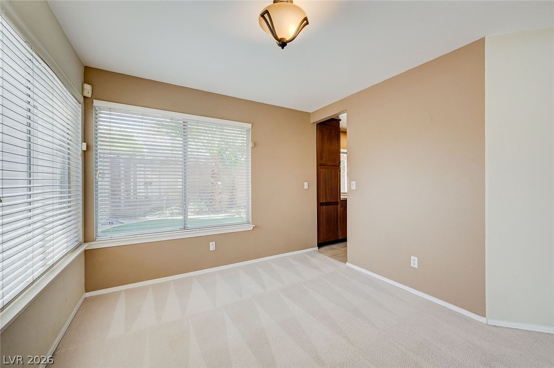 9301 Magic Flower Avenue Las Vegas, NV 89134 - Photo 12 of 70 An inviting room features a seamless transition to the kitchen, perfect for effortless living and entertaining.