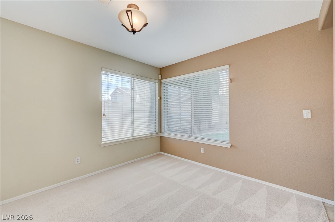 9301 Magic Flower Avenue Las Vegas, NV 89134 - Photo 14 of 70 This bright room features abundant natural light, offering a versatile space for living or working.