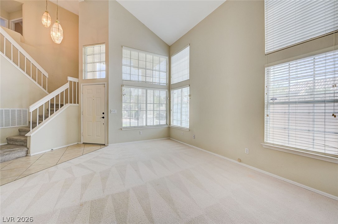 9301 Magic Flower Avenue Las Vegas, NV 89134 - Photo 15 of 70 This bright living area features vaulted ceilings and ample natural light, creating an inviting atmosphere.