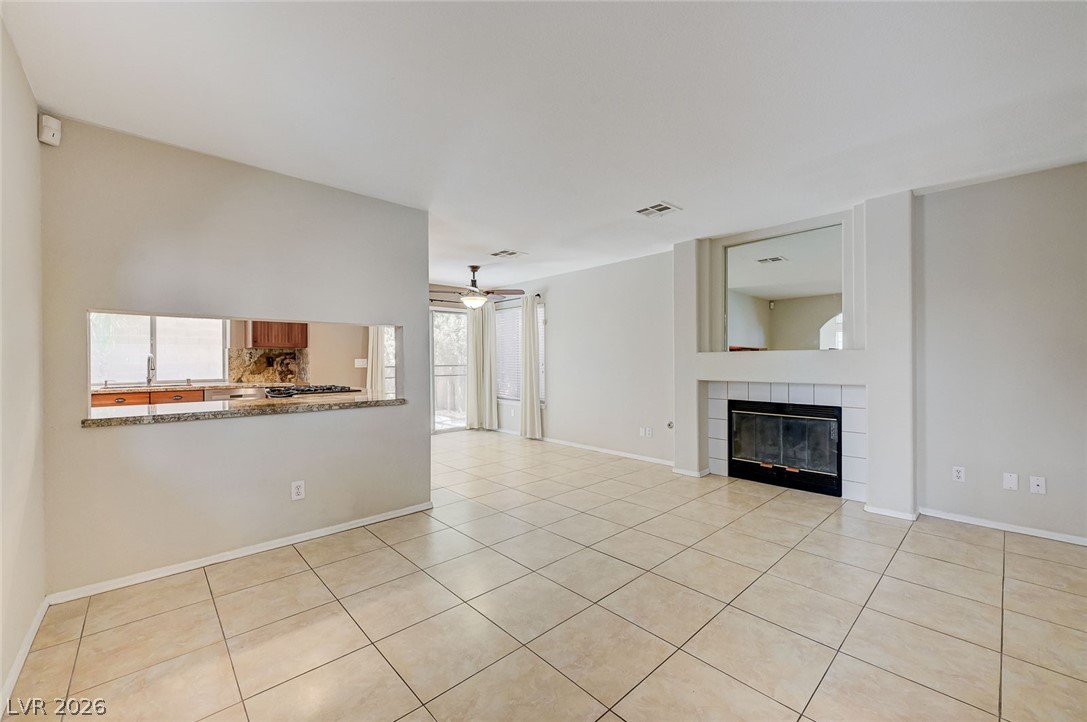 9301 Magic Flower Avenue Las Vegas, NV 89134 - Photo 16 of 70 This bright living space features a cozy fireplace and a convenient pass-through to the kitchen.