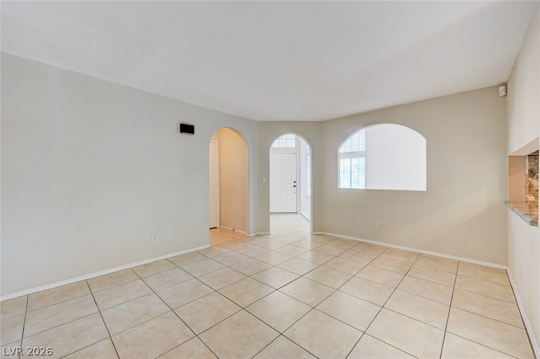 9301 Magic Flower Avenue Las Vegas, NV 89134 - Photo 18 of 70 This bright interior features architectural arches and durable tiled flooring.
