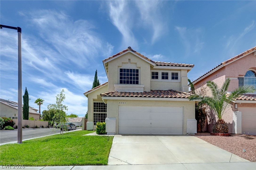 9301 Magic Flower Avenue Las Vegas, NV 89134 - Photo 2 of 70 This charming home offers a well-maintained exterior with attractive landscaping and a spacious driveway.