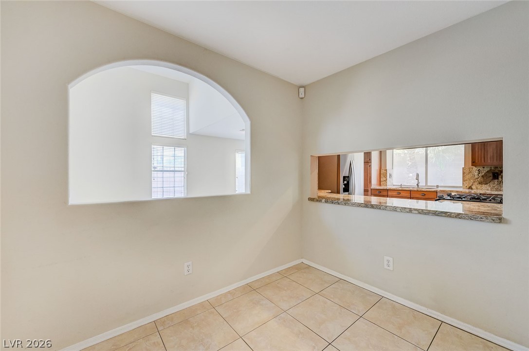 9301 Magic Flower Avenue Las Vegas, NV 89134 - Photo 20 of 70 This bright space features an open pass-through, connecting seamlessly to the kitchen, and durable tiled flooring.