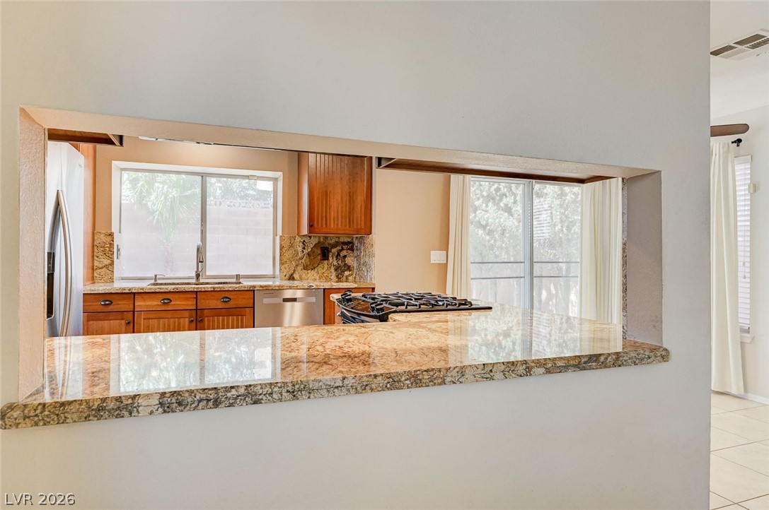 9301 Magic Flower Avenue Las Vegas, NV 89134 - Photo 21 of 70 This bright kitchen features a pass-through window and ample counter space, perfect for entertaining.