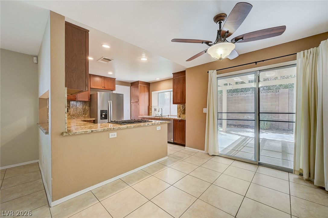 9301 Magic Flower Avenue Las Vegas, NV 89134 - Photo 23 of 70 This functional kitchen and dining area features convenient access to outdoor living.