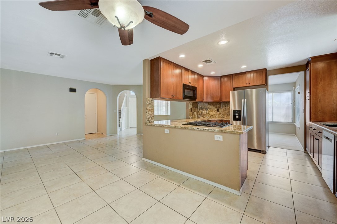 9301 Magic Flower Avenue Las Vegas, NV 89134 - Photo 24 of 70 This open concept living space features a well-appointed kitchen with an inviting breakfast bar.