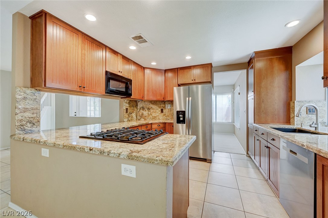 9301 Magic Flower Avenue Las Vegas, NV 89134 - Photo 25 of 70 This functional kitchen features ample counter space and modern appliances, perfect for everyday living.