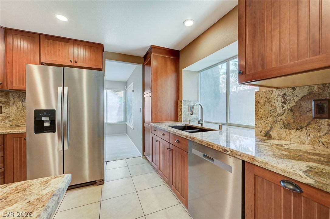 9301 Magic Flower Avenue Las Vegas, NV 89134 - Photo 27 of 70 This spacious kitchen offers ample granite counter space, modern appliances, and convenient access to an adjoining room.