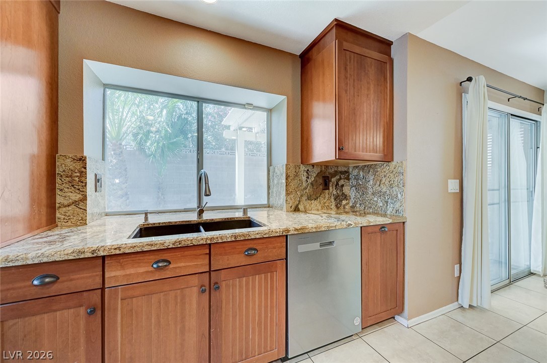 9301 Magic Flower Avenue Las Vegas, NV 89134 - Photo 28 of 70 This kitchen features rich cabinetry, ample counter space, and a bright window overlooking the outdoors.
