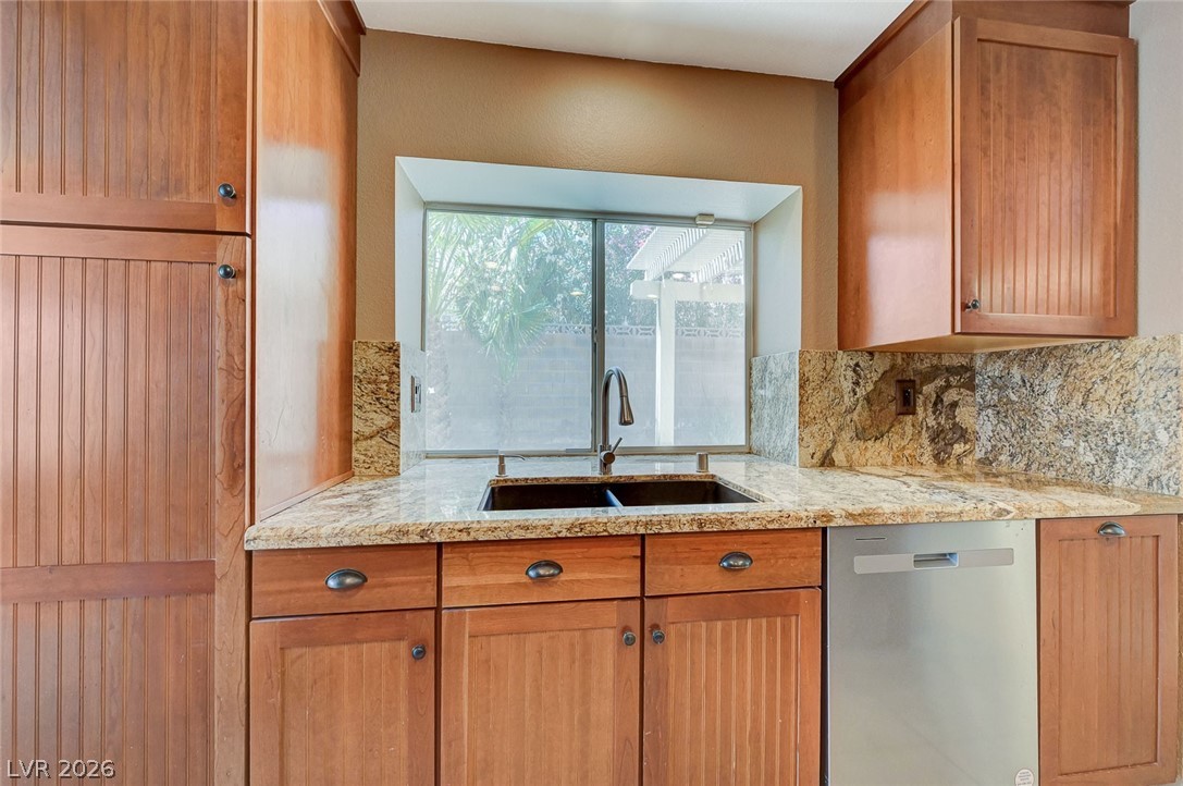 9301 Magic Flower Avenue Las Vegas, NV 89134 - Photo 29 of 70 This bright kitchen offers functional design with a window view and ample cabinet space.