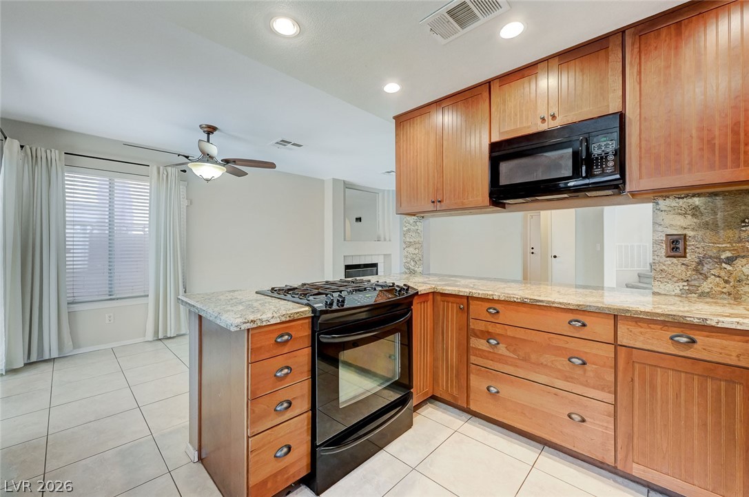 9301 Magic Flower Avenue Las Vegas, NV 89134 - Photo 30 of 70 This spacious kitchen offers a functional layout, ample cabinetry, and modern appliances for everyday living.