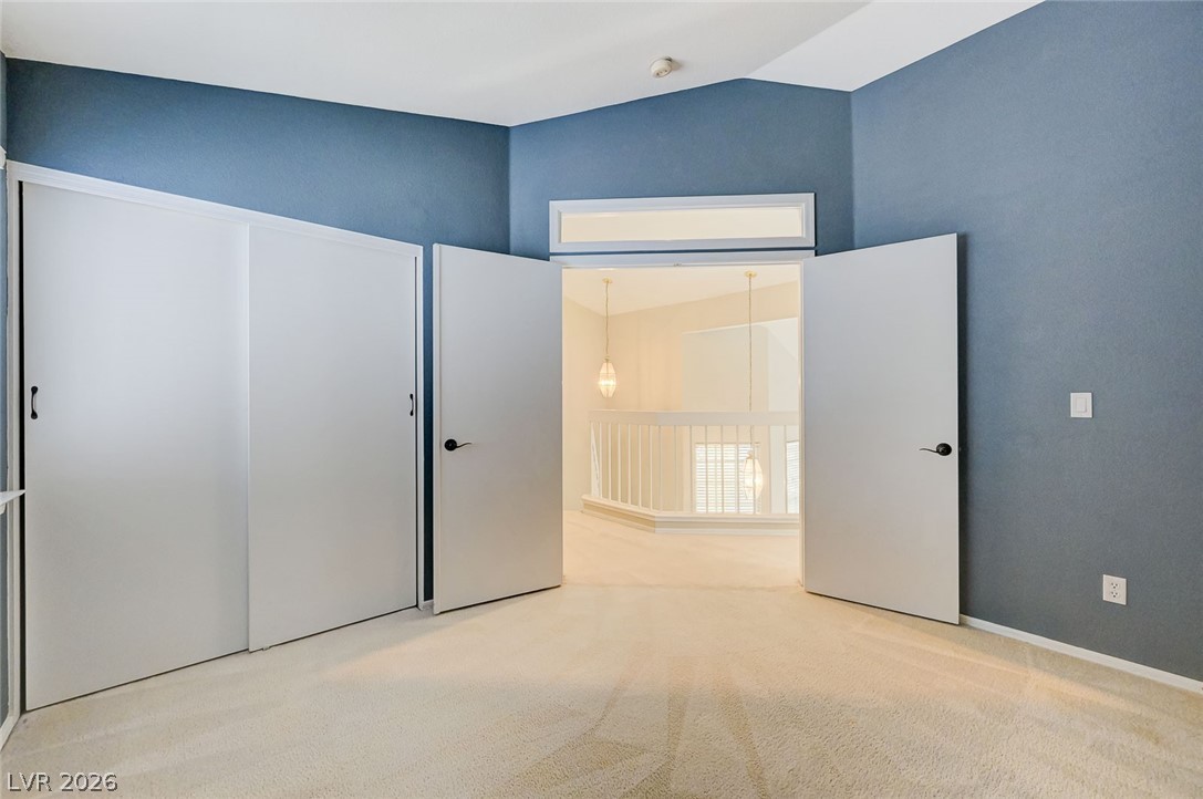 9301 Magic Flower Avenue Las Vegas, NV 89134 - Photo 40 of 70 This spacious room features vaulted ceilings, inviting an abundance of natural light.