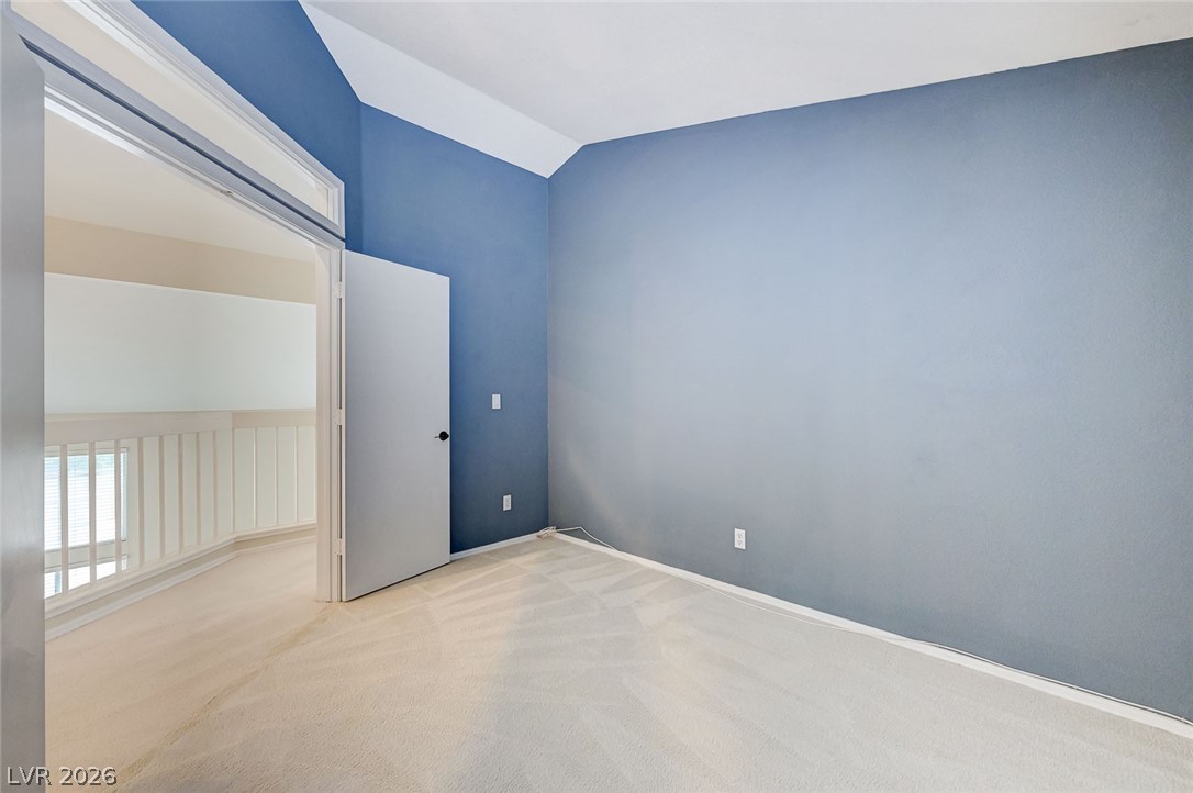 9301 Magic Flower Avenue Las Vegas, NV 89134 - Photo 41 of 70 This spacious room features vaulted ceilings, plush carpeting, and an adjoining open-concept hallway.