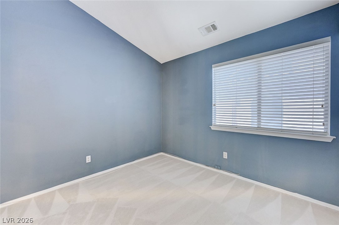 9301 Magic Flower Avenue Las Vegas, NV 89134 - Photo 42 of 70 This serene bedroom offers a calm retreat with ample natural light from its large window.