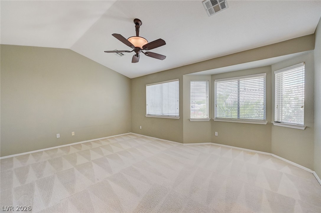 9301 Magic Flower Avenue Las Vegas, NV 89134 - Photo 43 of 70 This spacious bedroom offers comfortable carpeting and multiple windows for ample natural light.
