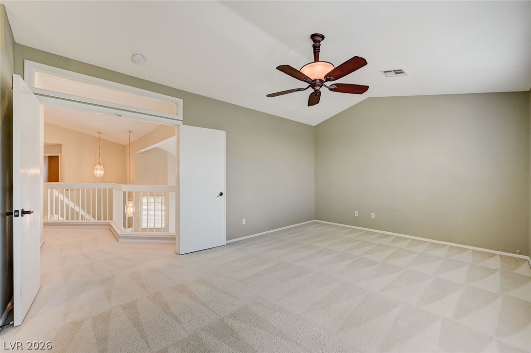 9301 Magic Flower Avenue Las Vegas, NV 89134 - Photo 44 of 70 This spacious room offers comfort and versatility with a beautiful vaulted ceiling.