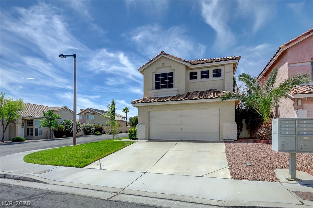 9301 Magic Flower Avenue Las Vegas, NV 89134 - Photo 4 of 70 This charming home offers a two-story design with an attached garage and a well-maintained front yard.