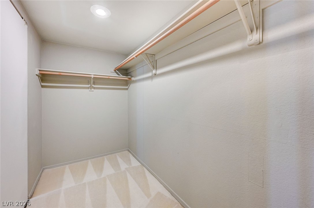 9301 Magic Flower Avenue Las Vegas, NV 89134 - Photo 50 of 70 This spacious walk-in closet offers ample storage and convenient organization solutions.