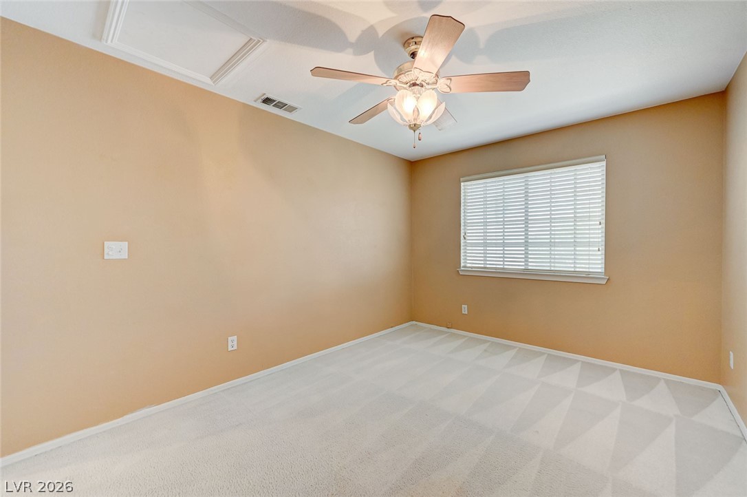 9301 Magic Flower Avenue Las Vegas, NV 89134 - Photo 52 of 70 Bright and airy room with plush carpeting offers comfort and versatility.