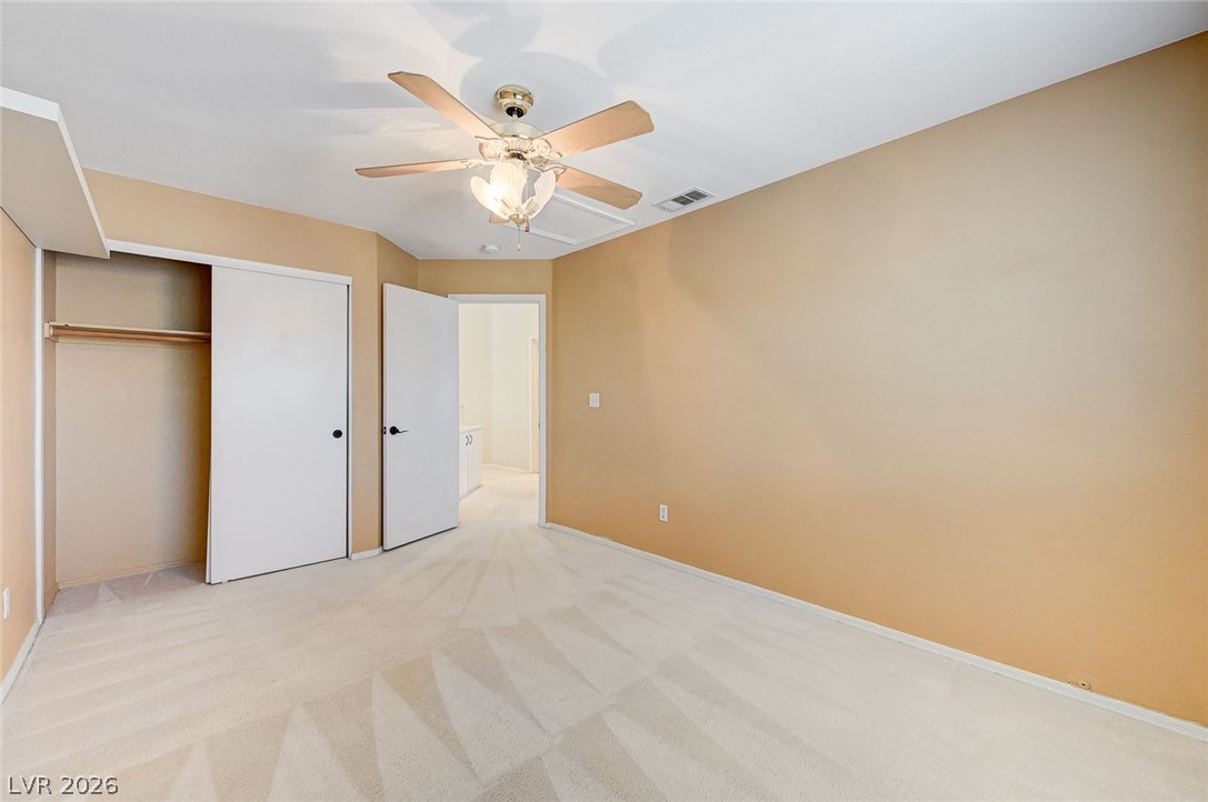 9301 Magic Flower Avenue Las Vegas, NV 89134 - Photo 53 of 70 This inviting bedroom features soft carpeting, offering comfort and warmth to this private space.