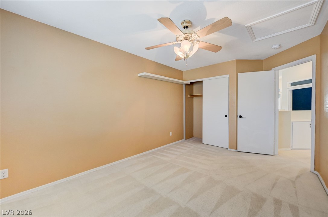 9301 Magic Flower Avenue Las Vegas, NV 89134 - Photo 54 of 70 This bedroom offers a neutral palette, carpeted floors, and a ceiling fan for comfort.